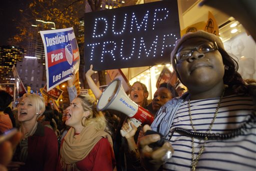 Sasha Murphy of the ANSWER Coalition leads demonstrators in a chant during a protest against Republican presidential candidate Donald Trump's hosting'Saturday Night Live in New York Saturday Nov. 7 2015. Despite a 40-year history of lampooning poli