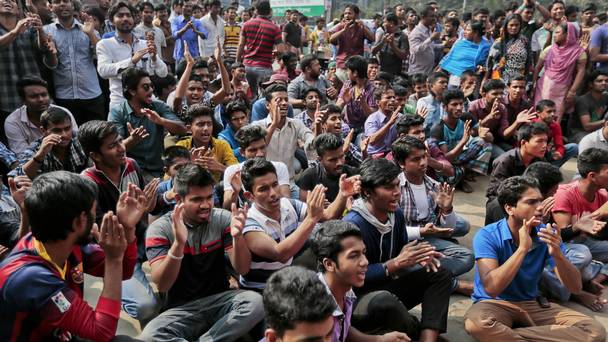 Bangladeshi pro-government activists shout slogans against a nationwide strike called by Jamaat-e Islami in Dhaka after death sentences given to two influential opposition leaders were upheld