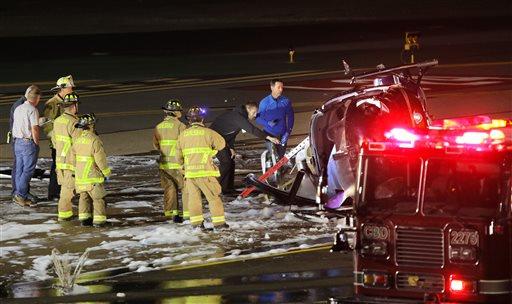 Emergency personnel investigate the scene of a helicopter wreck at Palomar Airport in Carlsbad Calif. Wednesday Nov. 18 2015. The helicopter crashed and caught fire shortley before 4:30 p.m. Wednesday at McClellan-Palomar Airport in Carlsbad killing