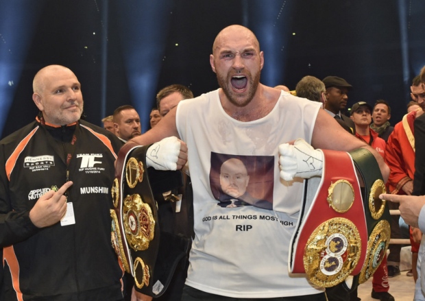 Tyson Fury celebrates with the WBA IBF WBO and IBO belts