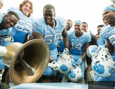 UNC players celebrate with Victory Bell after dominating Duke