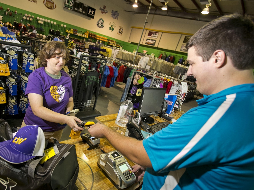 April Thompson makes a purchase at Legacy Team Sales in Ocala Fla. Sept. 8. Economists say October's surprisingly strong job growth will encourage the Federal Reserve to hike interest rates next month. So holiday shoppers may pay more for using cre