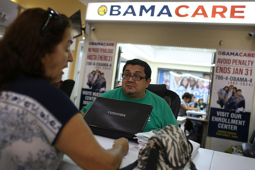 Consumer sits with insurance agent as she picks an insurance plan available in the third year of the Affordable Care Act