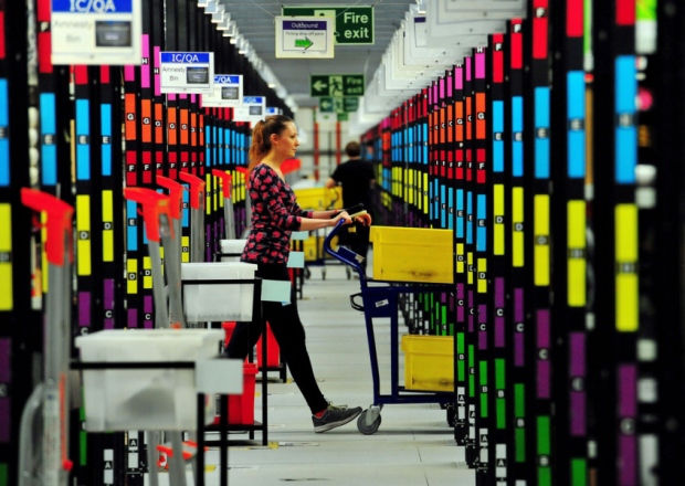 An associate picks up customer orders at the Amazon fulfillment centre in Hemel Hempstead Hertfordshire as it prepares for Black Friday and the busy Christmas period