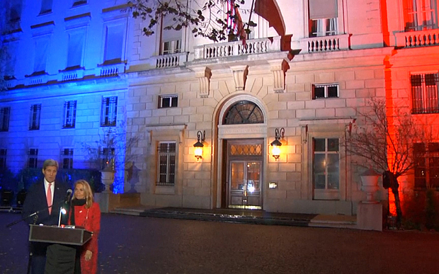 United States Secretary John Kerry speaks outside the US embassy in Paris coloured in the French flapg