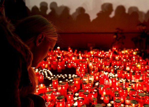 VADIM GHIRDA						Credit AP				A girl lights candles Saturday in Bucharest Romania for victims of a nightclub fire that started during a heavy-metal concert