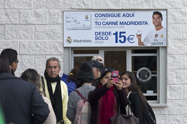 Fans queue up to buy match tickets outside the Santiago Bernabeu stadium in Madrid Spain Wednesday Nov. 18 2015. The attack by extremists in Paris have prompted Spanish authorities to schedule an extraordinary meeting to discuss security measures for