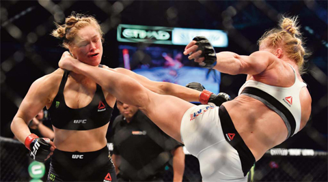 MELBOURNE Holly Holm of the US lands a kick to the neck to knock out compatriot Ronda Rousey and win the UFC title fight in Melbourne yesterday. — AFP