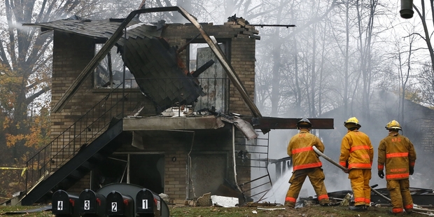 Loading Firefighters work at the scene where authorities say a small business jet crashed into an apartment building in Akron Ohio