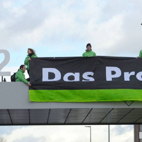 Greenpeace activists stand with'CO2 formed with the VW logo and a banner that reads'the problem above the Volkswagen factory gate in Wolfsburg Germany. California air quality regulators on Wednesday