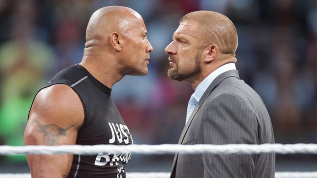 FILE Dwayne the Rock Johnson stares off against WWE superstar Triple H at Wrestle Mania 31 on Sunday