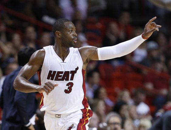 Dwyane Wade celebrates after scoring during the first half of an NBA basketball game against the Philadelphia 76ers Saturday Nov. 21 2015 in Miami