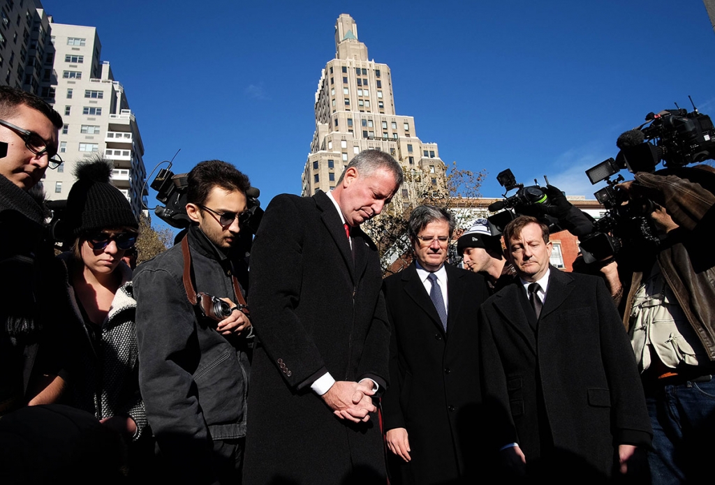 New York City Mayor Bill de Blasio, is joined by French representative to the United Nations Francois Delattre and consul general of France in New York Bertrand Lortholary pay their respects during a vigil to show solidarity with the citizens