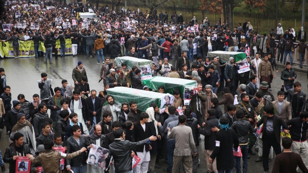 Protesters march through the Afghan capital of Kabul on Wednesday Nov. 11 2015 carrying the coffins of seven ethnic Hazaras who were allegedly killed by the Taliban and calling for a new government that can ensure security in the country. (AP