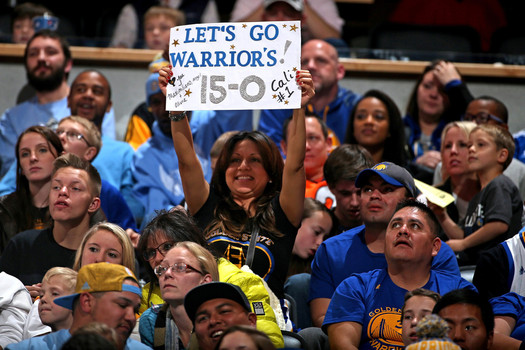 Fans celebrate the Golden State Warriors 15-0 season start with their 118-105 victory over the Denver Nuggets at Pepsi Center