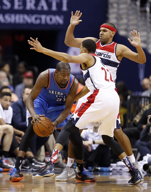 Oklahoma City Thunder forward Kevin Durant is double-teamed by Washington Wizards guards John Wall and Jared Dudley during the first half of an NBA basketball game Tuesday Nov. 10 2015 in Washington