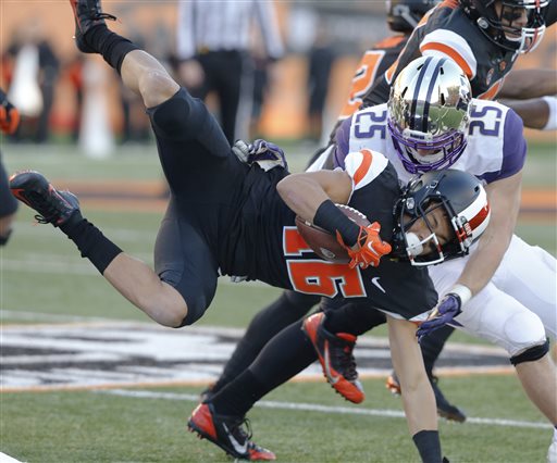 Oregon State's Paul Lucas front is tackled by Washington's Ben Burr Kirven during the first half of an NCAA college football game in Corvallis Ore. on Saturday Nov. 21 2015