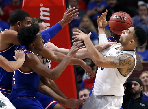 Michigan State guard Denzel Valentine right battles for a rebound the ball against Kansas during the second half of an NCAA college basketball game on Tuesday Nov. 17 2015