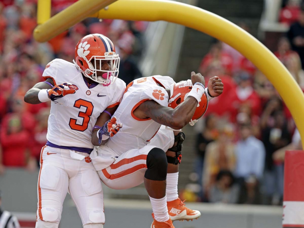 Clemson's Artavis Scott and quarterback Deshaun Watson celebrate Watson's touchdown against North Carolina State during the first half of an NCAA college football game in Raleigh N.C. Saturday Oct. 31 2015