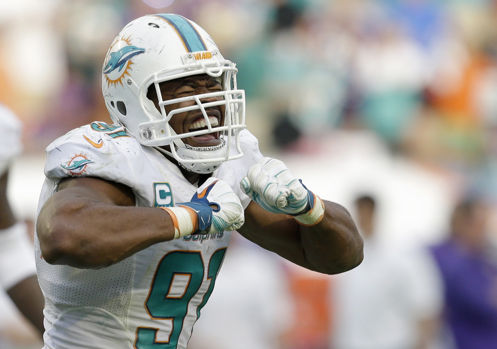 Miami Dolphins defensive end Cameron Wake celebrates after sacking Minnesota Vikings quarterback Teddy Bridgewater during the second half of an NFL football game Sunday Dec. 21 2014 in Miami Gardens Fla. The Dolphins won 37-35