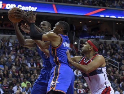 Wizards forward Jared Dudley battles for a rebound against a pair of Thunder players on Tuesday night