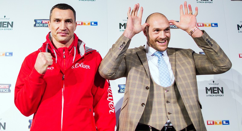 Ukraine’s Wladimir Klitschko and Britain’s Tyson Fury pose during a press conference on Tuesday in Duesseldorf ahead of their boxing fight for the WBA WBO and IBF titles