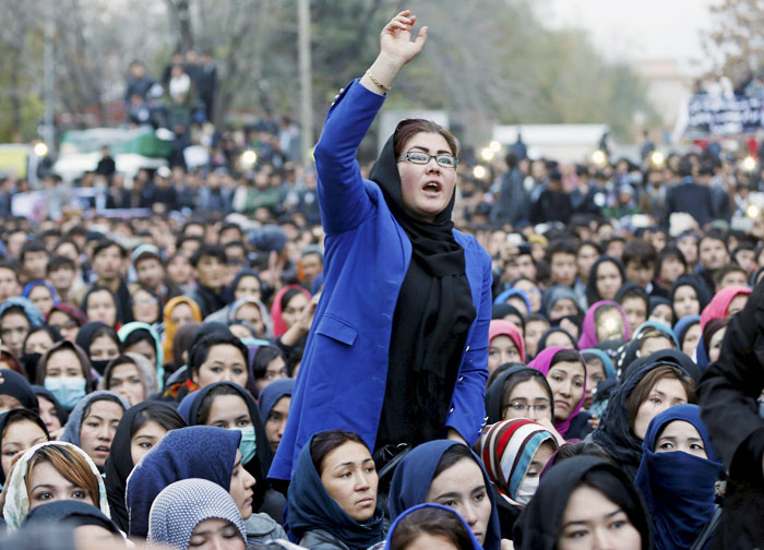 Women chat slogans during a protest against the killing of seven people from the Hazara community in Kabul Afghanistan