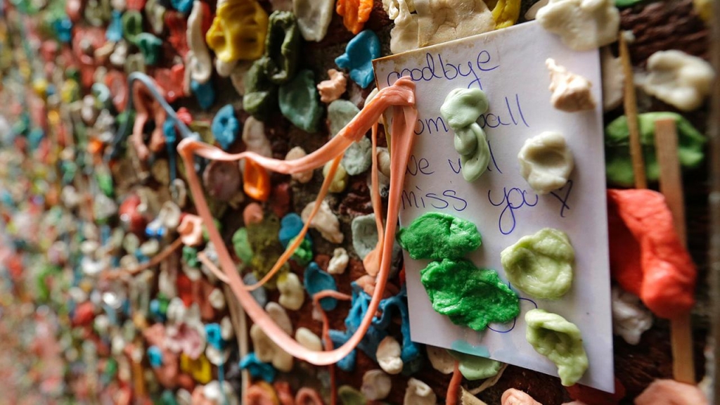 A note that reads Goodbye gum wall we will miss you sticks to a wall partially obscured by gum Monday Nov. 9 2015 at Seattles gum wall at Pike Place Market