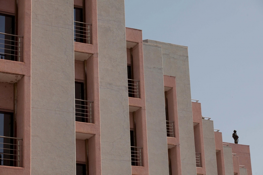 A soldier stands guard on the roof before the arrival of Mali's President Ibrahim Boubacar Keita at the Radisson hotel in Bamako Mali