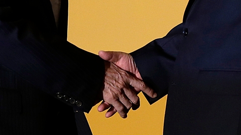 Xi Jinping and Ma Ying Jeou locked hands and rotated to give the whole room a view of the historic occasion