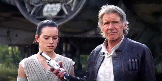 Han passes a blaster to Rey