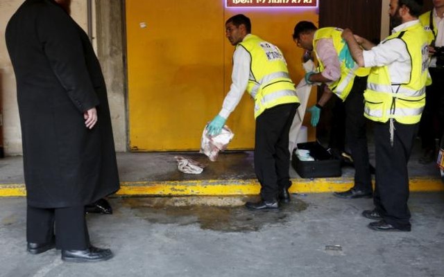 Zaka emergency personnel clean a bloodstain from the ground at the scene of a Palestinian stabbing attack in Tel Aviv Israel Nov 19 2015. Reuters