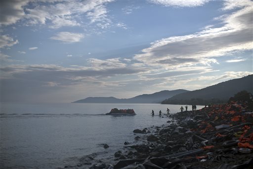 A boat carrying migrants and refugees arrives at a beach on the northern shore of Lesbos Greece Tuesday Nov. 10 2015. Well over half a million people have reached the Greek islands so far this year a record number of arrivals and the journey has pro