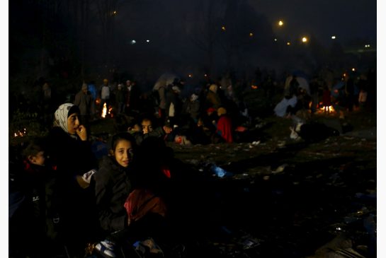 Migrants wait to cross the Austrian border in Spielfeld near the village of Sentilj Slovenia on Sunday. More than 218,000 refugees and other migrants crossed the Mediterranean in October — a record monthly tally this year and more than in the whole