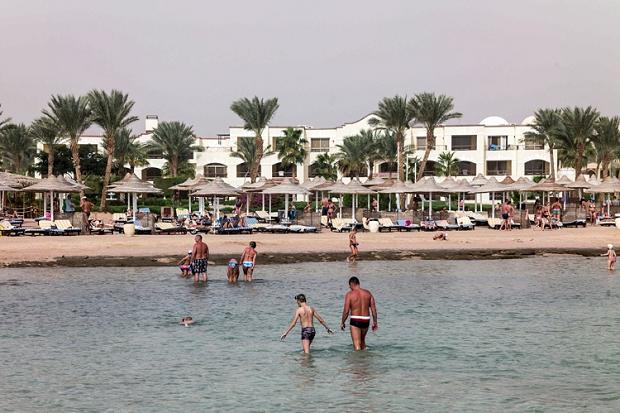 Tourists play in the sea at a resort in Sharm El-Sheikh