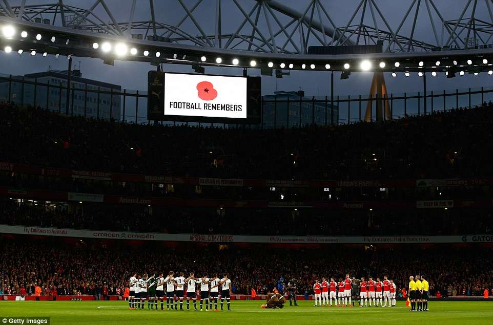 Arsenal and Tottenham players holding a one-minute silence for Remembrance Day in England