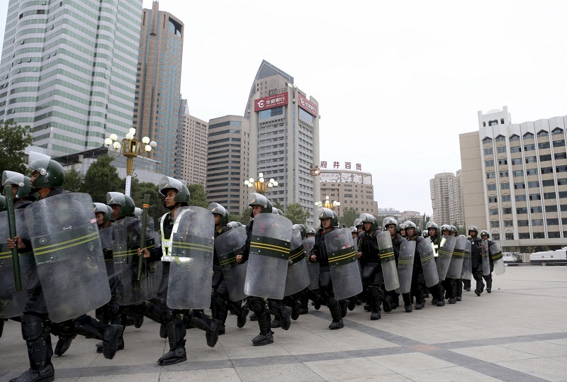 Armed paramilitary policemen run in formation during a gathering to mobilize security operations in Urumqi Xinjiang Uighur Autonomous Region in this