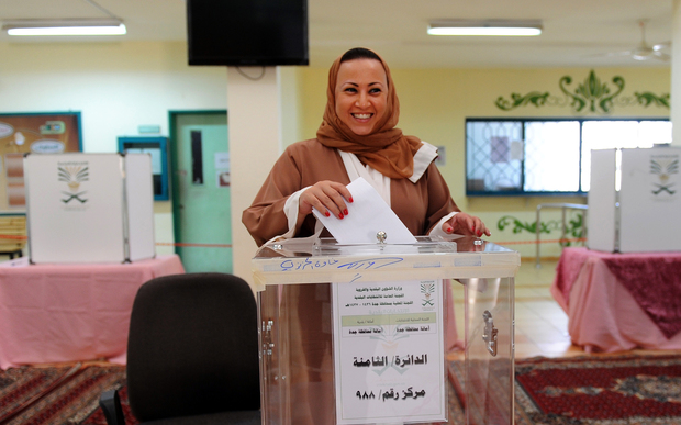 A Saudi woman arrives at a polling station to vote for the municipal elections