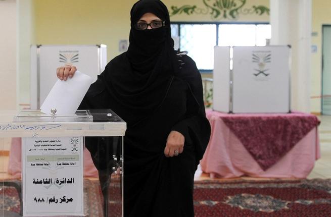 A Saudi woman casts her ballot in a polling station in the coastal city of Jeddah