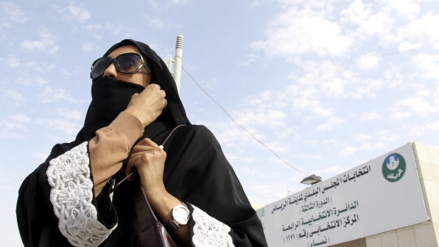 A Saudi woman leaves a polling station after casting her vote during municipal elections in Riyadh on Saturday