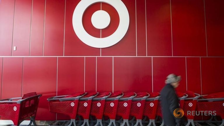 A man walks by shopping carts during the going-out-of-business sale at Target Canada in Toronto