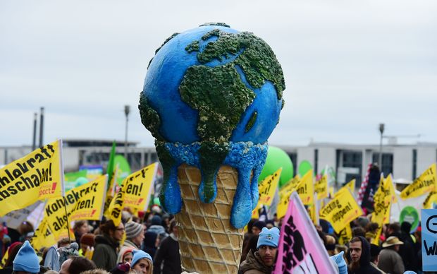 A melting planet in an ice cream cone carried during the climate change march in Berlin Germany