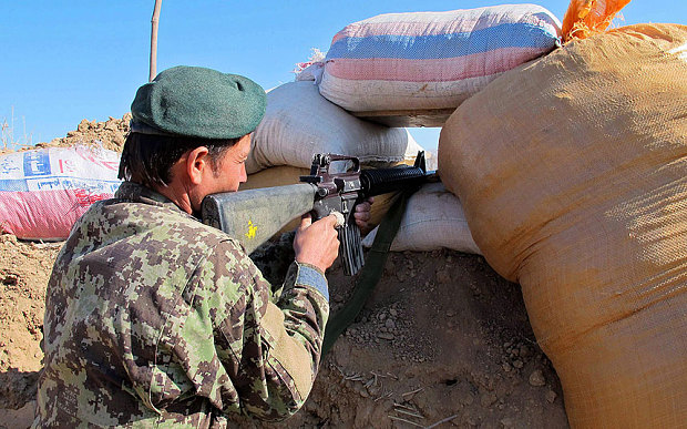 A member of the Afghan security forces takes up a position during an operation against Taliban fighters in Helmand province Afghanistan 22 December 2015