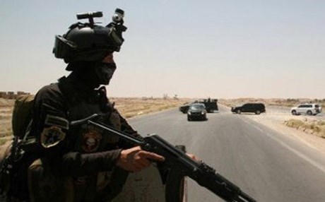 A member of the Iraqi security forces keeps watch on the main highway near Ramadi. AFP file