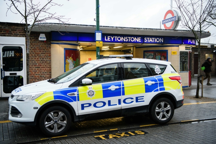 A police car is seen parked outside Leytonstone station in north London on Sunday