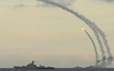 A still image taken from video footage shows Russian navy ships launching cruise missiles at targets in Syria in the Caspian sea