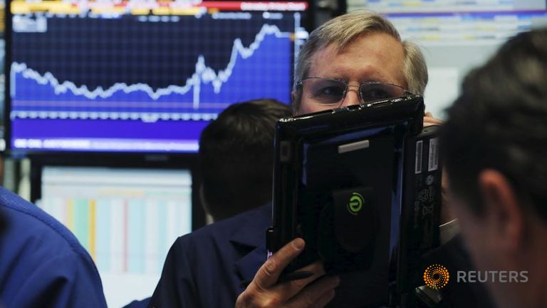 A trader works on the floor of the New York Stock Exchange shortly after the opening bell in New York