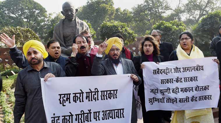 AAP and Trinamool Congress MPs during a protest against Delhi slum demolition at the Gandhi statue outside Parliament in New Delhi on Monday. PTI