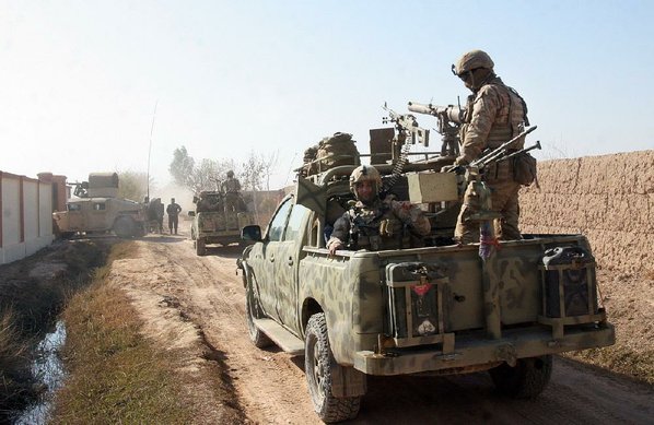 ABDUL KHALIQ							Credit AP				Afghan security forces patrol Tuesday in the Nad Ali district of Helmand province Afghanistan