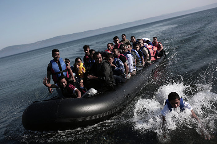 Refugees coming from Turkey land on the shores of the Greek island Lesbos in an inflatable boat